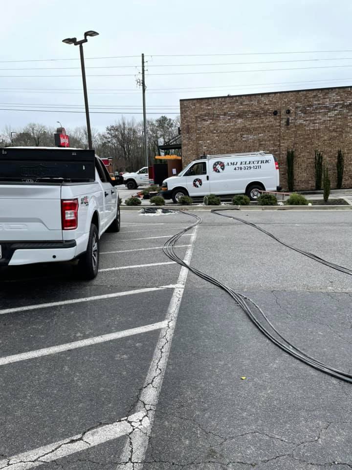AMJ Electric van on a commercial job site in Warner Robins, GA