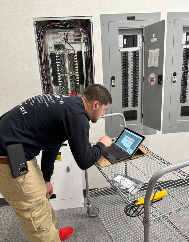 AMJ Electric technician programming a commercial panel in Warner Robins, GA